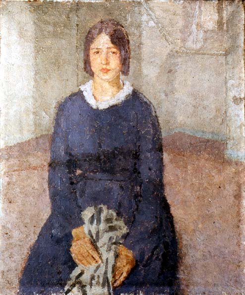 Girl in a blue dress holding a piece of sewing