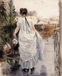 Young Woman Watering A Shrub